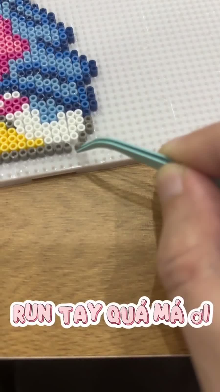 Close-up of pixel bead making