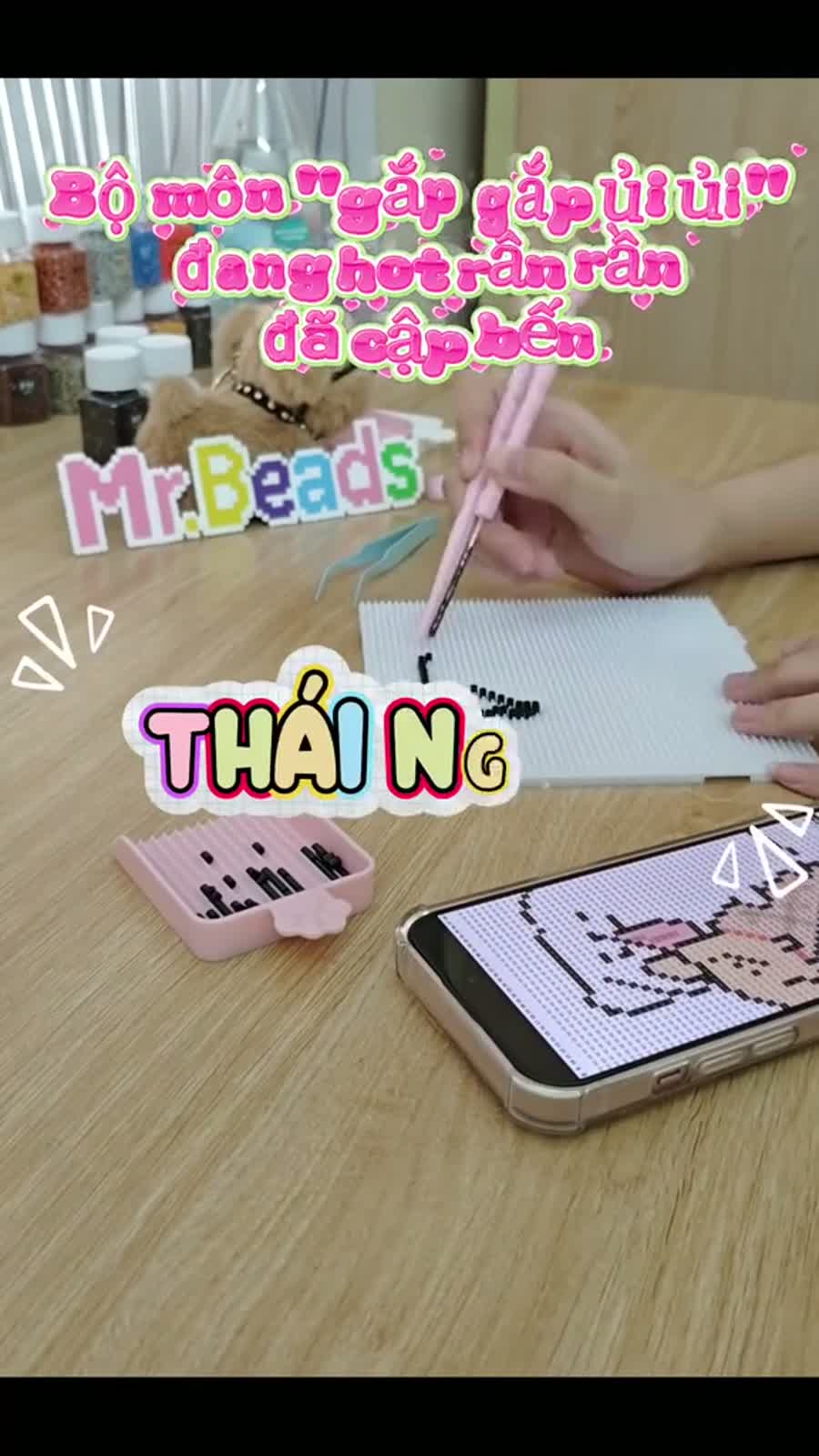 Customer making pixel bead artwork at a table